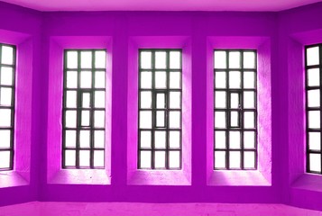 Abstract view of symmetrical windows on purple wall
