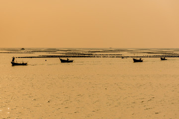 silhouette of Small fishing boats on the sea during sunset
