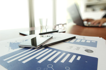 business documents on office table with smart phone and digital