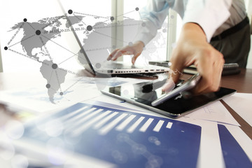 business documents on office table with digital tablet and man w