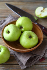 Nutritious green apple in a clay bowl