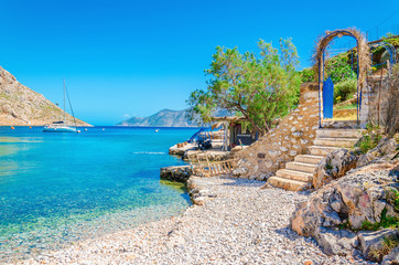 Stairs from sandy beach on Greece island Kalymnos - obrazy, fototapety, plakaty