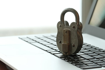 Internet security concept-old padlock and key on laptop computer