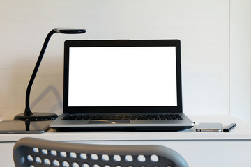 blank  screen laptop computer with table lamp is on twooden desk