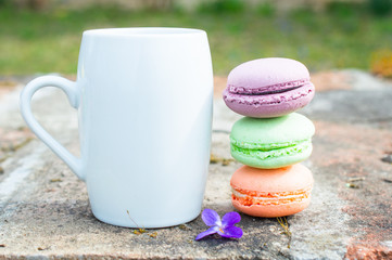 Colorful macarons with coffee mug