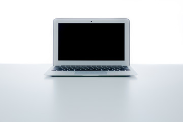 Fototapeta premium Still-life portrait of computer, pen, coffee mug on table, busin