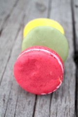Macaroons colorful delicious on wood background.