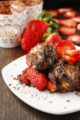 Profiteroles with strawberries and chocolate sauce