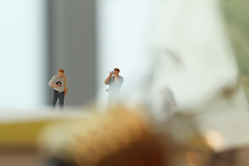 Creative idea concept - miniature photographer with vintage ligh