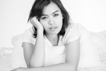 Portrait of a beautiful young woman in bed