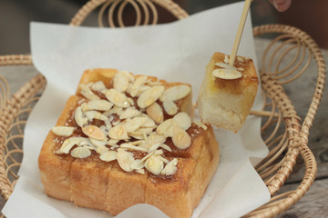Toast topped with almonds and honey.