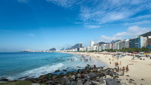  People playing and swimming on the crowded Copacabana Beach in Rio De Janeiro, Brazil.