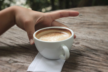 latte coffee in cup on wood background