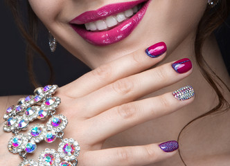 Fototapeta premium girl with a bright make-up and manicure with rhinestones. 