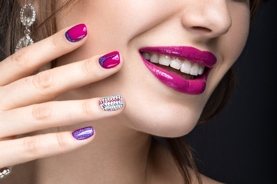 girl with a bright make-up and manicure with rhinestones. 