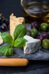 Tapas style cheese selection with olives,grapes and herbs