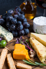 Cheese board with fresh grapes,herbs and olives