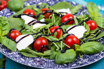 Obraz na płótnie Canvas Healthy diet salad with tomatoes, mozzarella,basil and balsamic