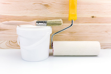 paint roller with paint can and brush