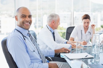 Team of smiling doctors having a meeting
