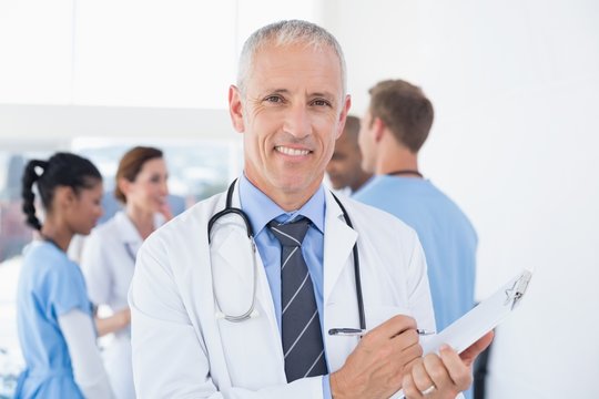 Confident male doctor smiling at camera