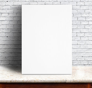 Black White paper poster lean at white brick wall and marble tab