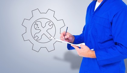 Composite image of midsection of mechanic writing on clipboard
