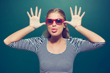 Young girl making face in front of blackboard