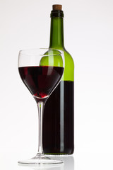 Wine glass and bottle with red wine