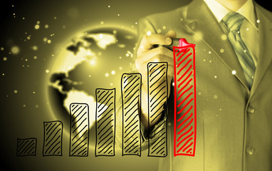 Business man drawing a growing graph