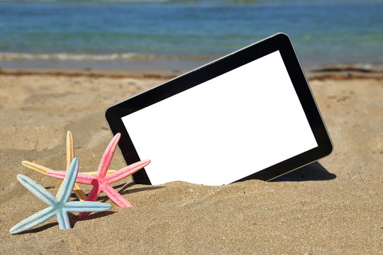 Tablet Computer On Sandy Beach