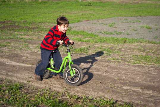 little boy rides a bicycle