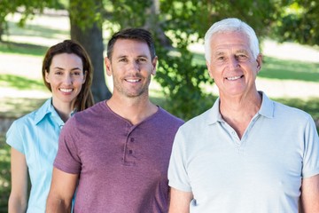 Extended family smiling in the park