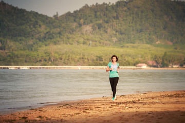 girl runs from distance on beach at low tide