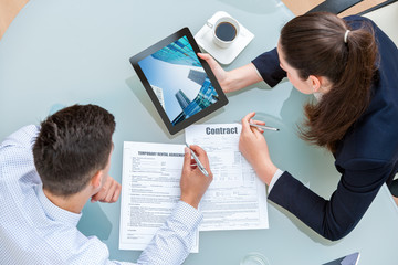 Young business couple discussing rental agreement.