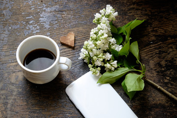 porcelain cup with coffee. lilac and a telephone