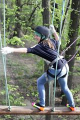 Girl climbing at adventure park