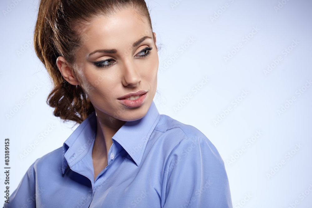 Wall mural portrait of a beautiful young business woman standing against bl