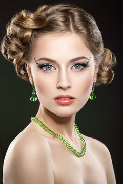Beautiful girl with evening hairstyle and bright  green makeup
