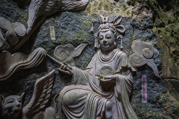 Fototapeta na wymiar Sculpture of Buddha inside Am Phu Cave Danang