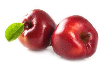 Ripe apple with a leaf.