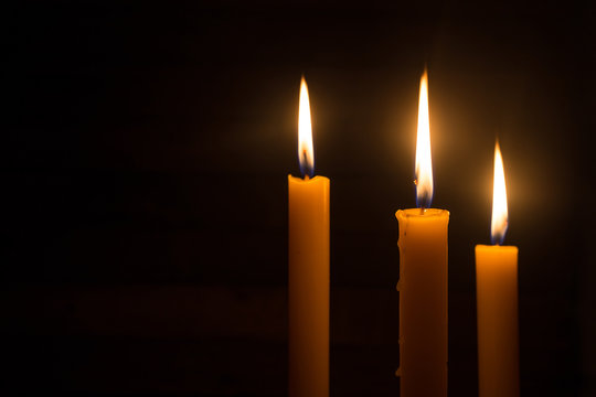 Three candles light in darkness  as light for life