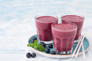 Blueberry smoothie with fresh berries and sprig of mint 