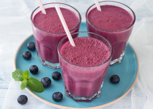 Blueberry smoothie with fresh berries and sprig of mint 