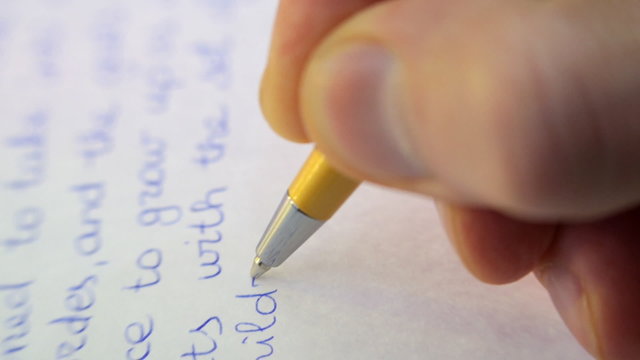 Pen writes a letter on paper