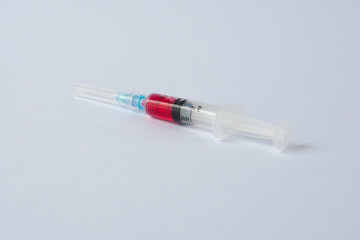 syringe with red liquid