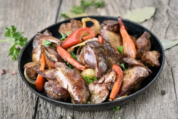 Gardinen Grilled chicken liver in frying pan © voltan