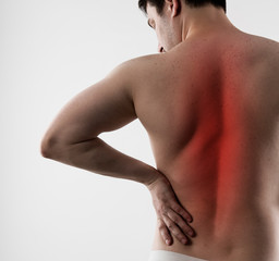 Fototapeta na wymiar Back inflammation and ache. Young man having backbone disease 