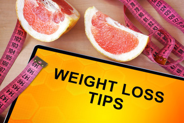 Tablet with weight loss tips. Weight loss concept. 