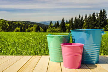 Garden buckets on wooden table